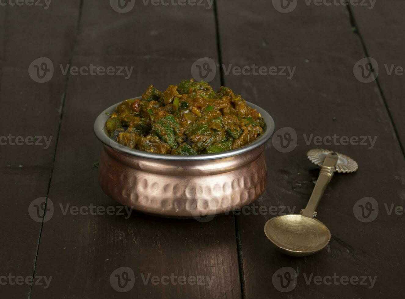 Indian Cuisine Bhindi Masala on Wooden Background photo