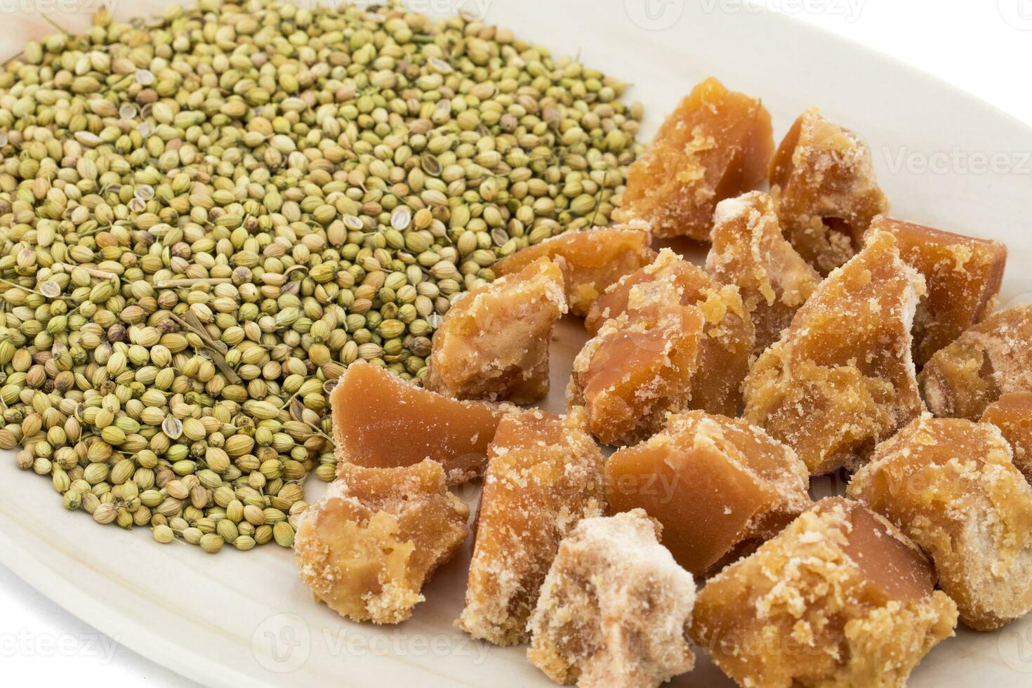 Group of jaggery with Coriander Seeds on White Background photo