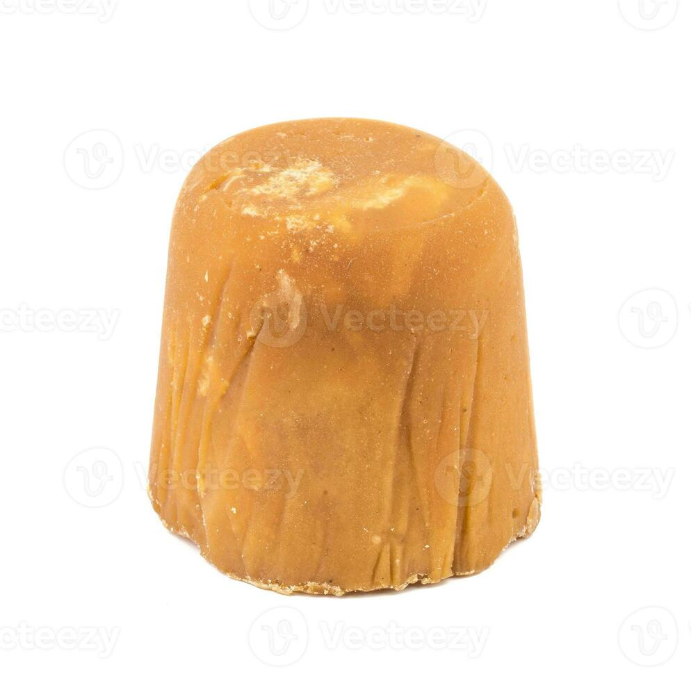A Block of Indian Jaggery Cane Sugar on white background photo
