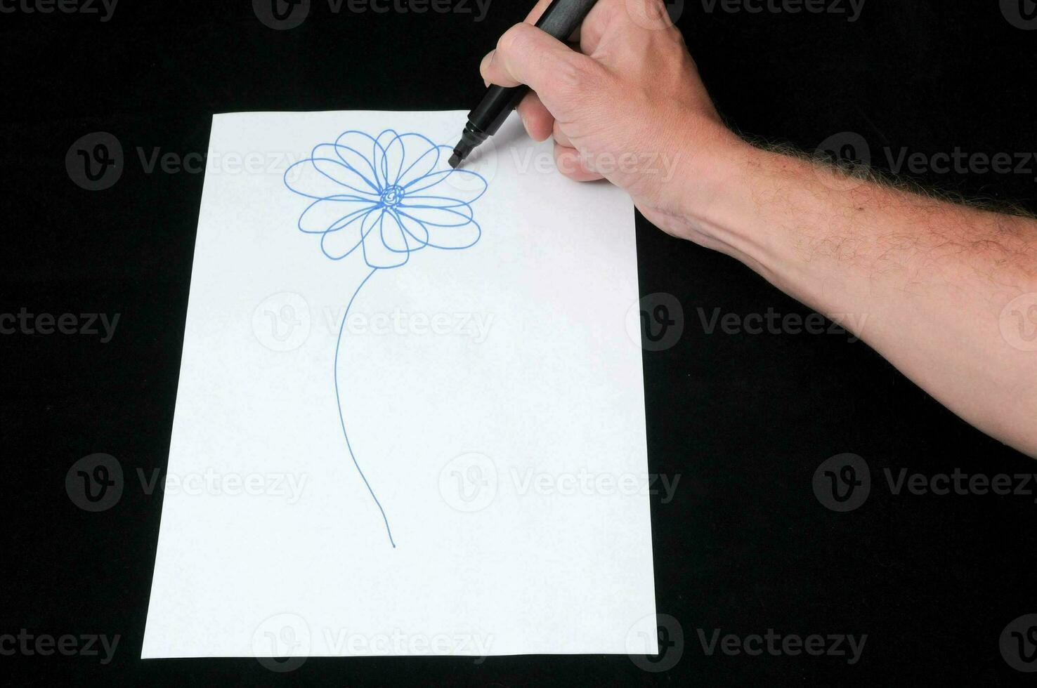 man drawing a flower photo