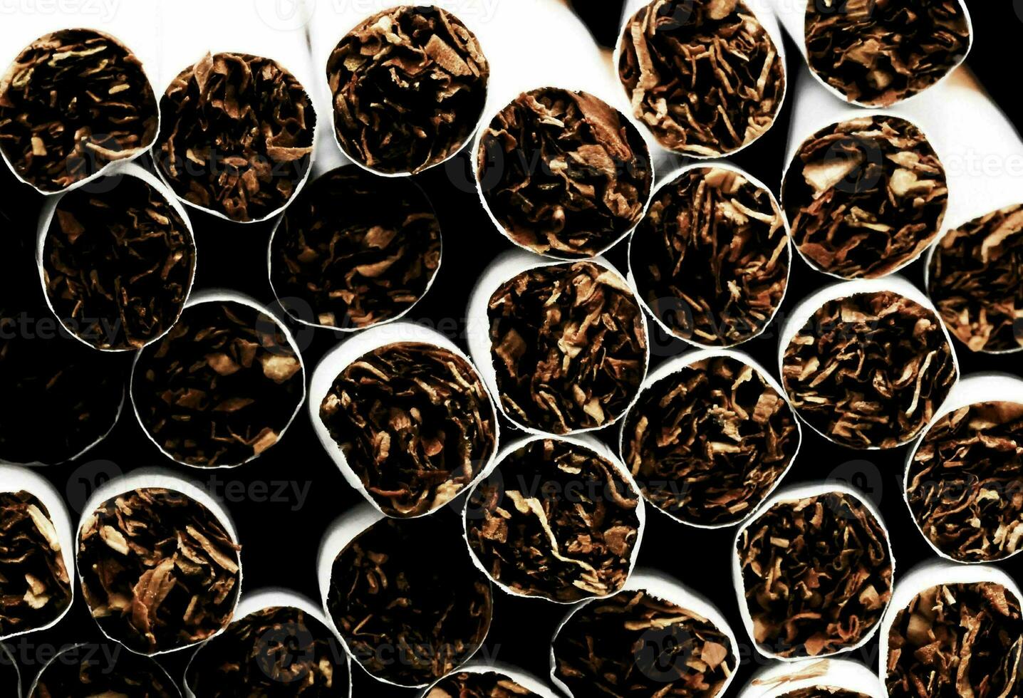 a close up of a pile of cigarettes photo