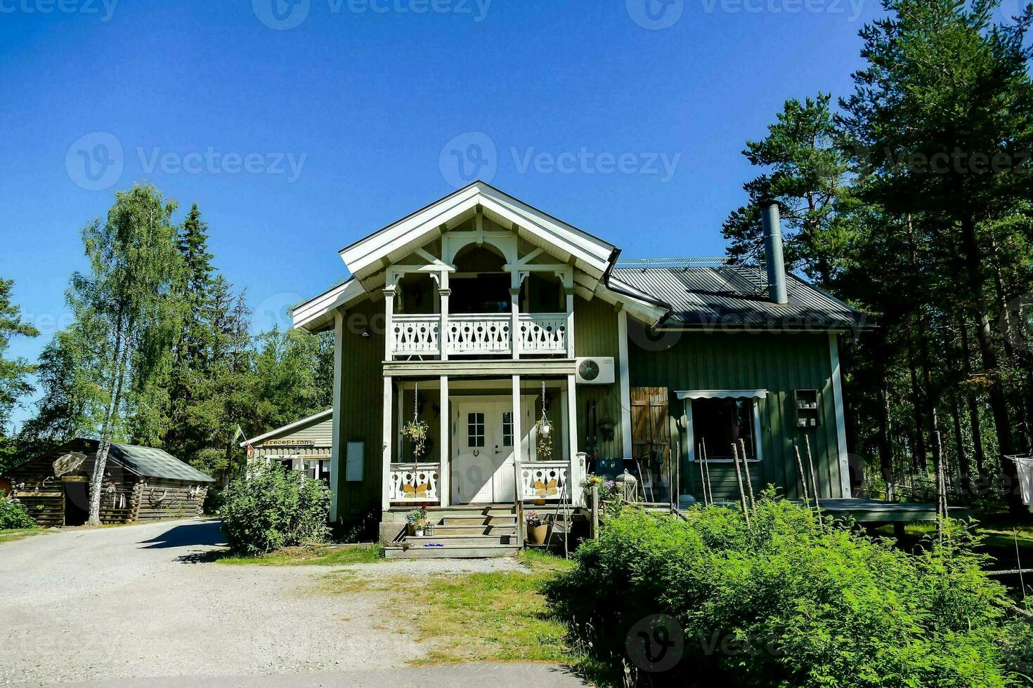 a green house with a porch photo