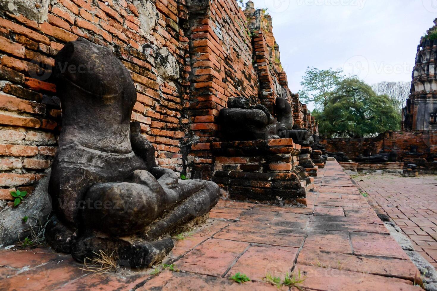 ancient buddha statues in the ruins of wat phra located in thailand photo