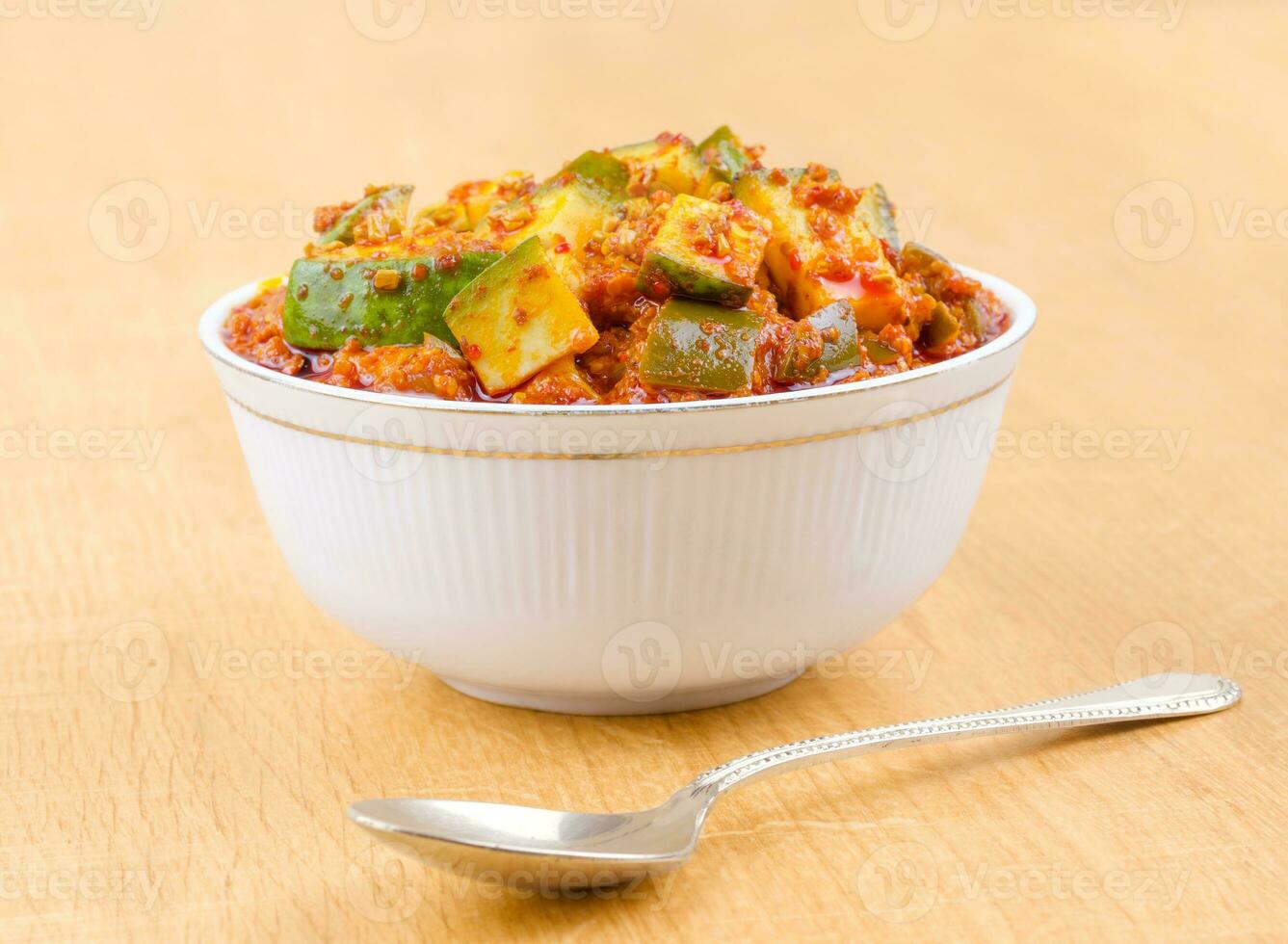 Indian Traditional Raw Mango Pickle on Wooden Background photo