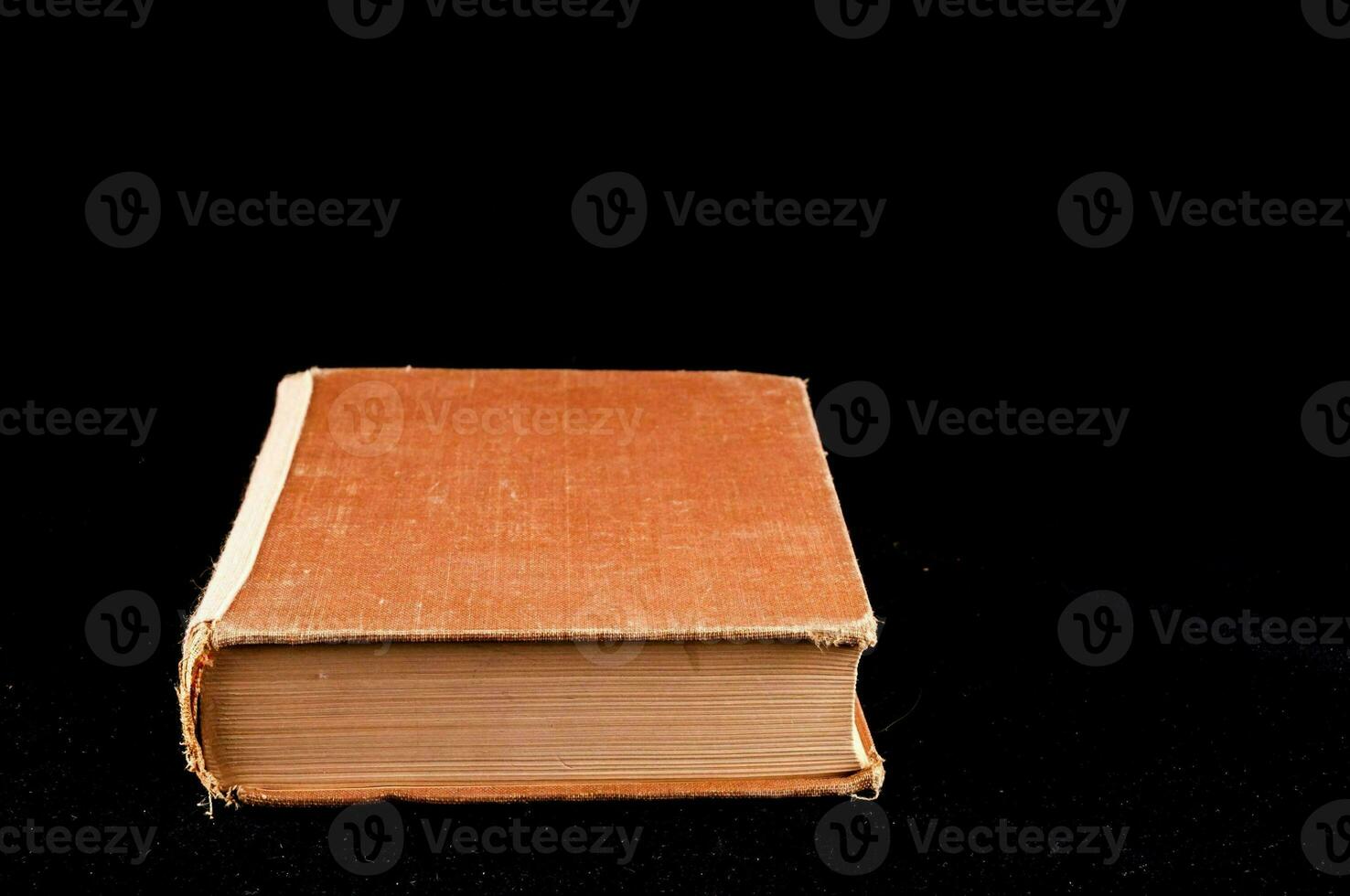 an old book on a black background photo