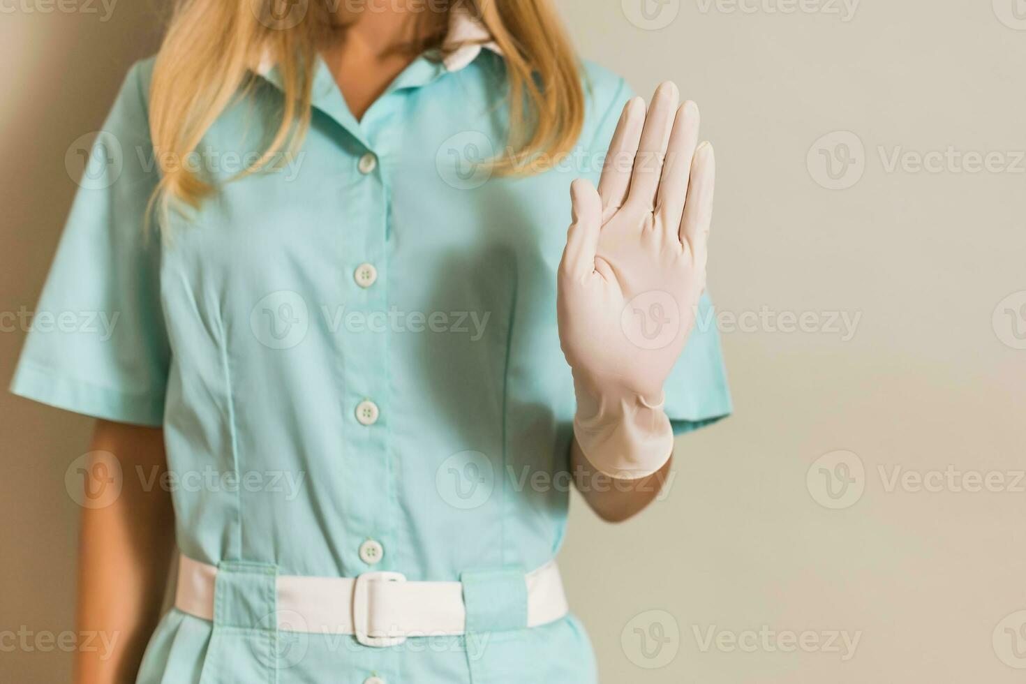 Image of medical nurse showing stop sign. photo