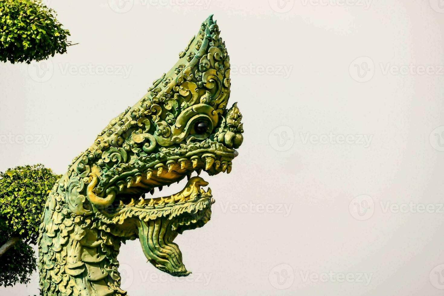 a dragon statue with green and gold decorations photo