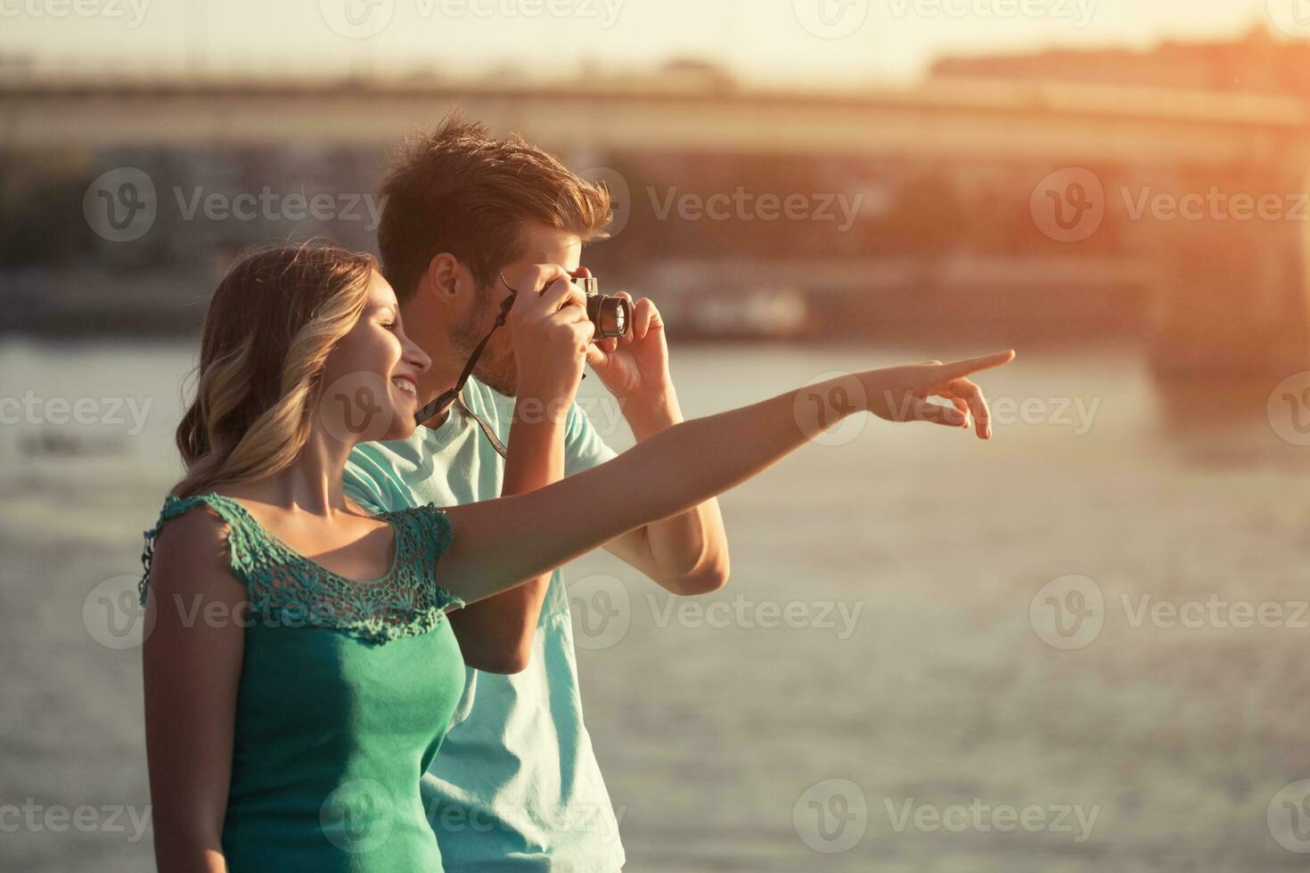 Young happy couple photographing together. photo