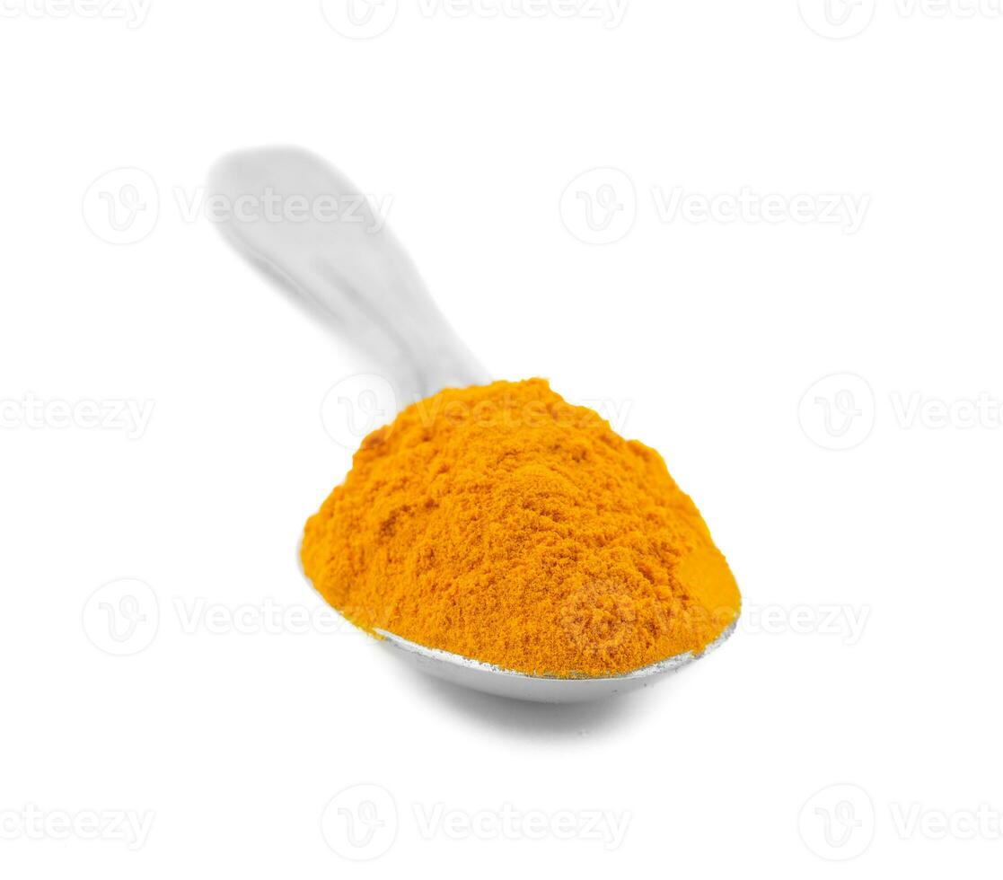 Turmeric Powder in Spoon on White Background photo