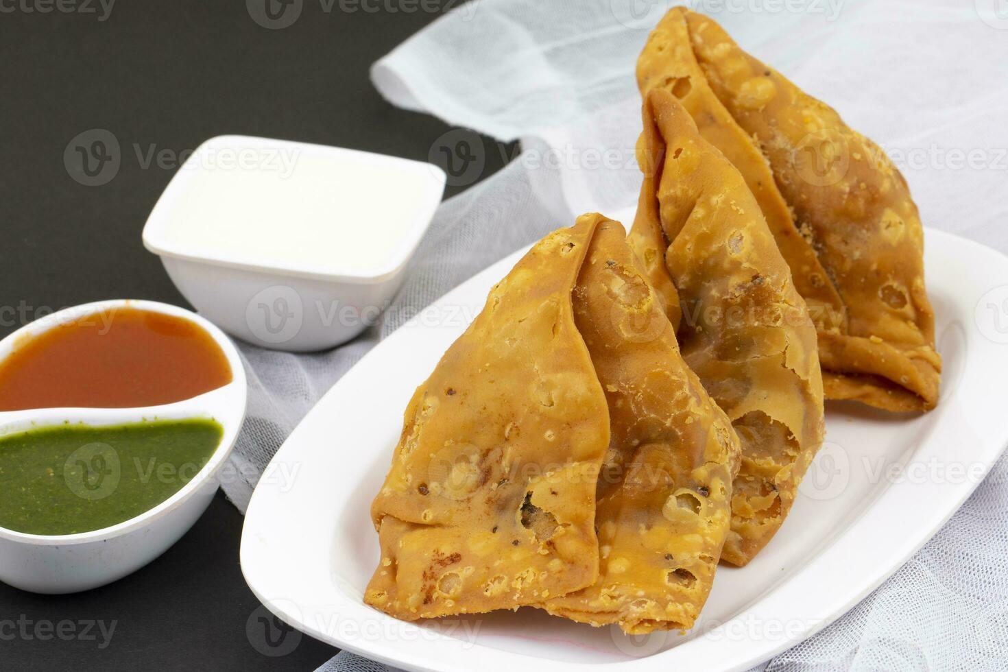 Indian Street Food Samosa or Samosas is a Crispy And Spicy Triangle Shape Snack photo