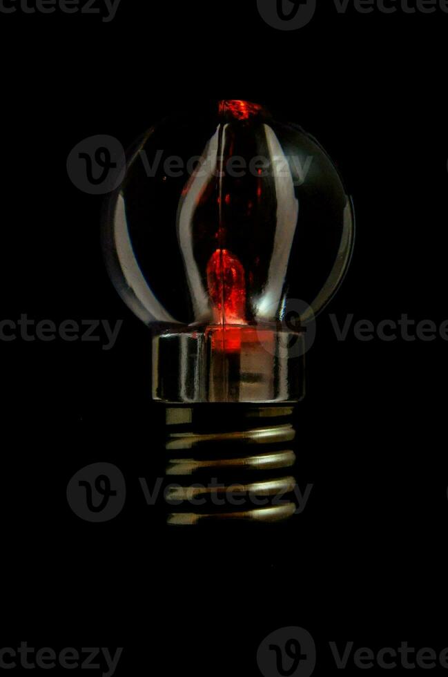 a red light bulb in the dark photo