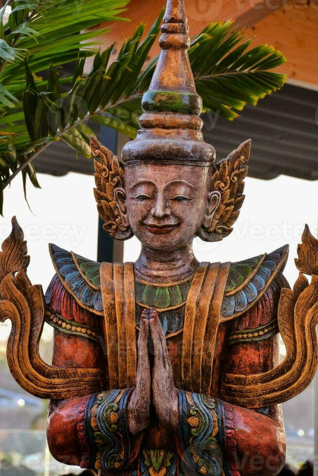 a statue of a thai god photo