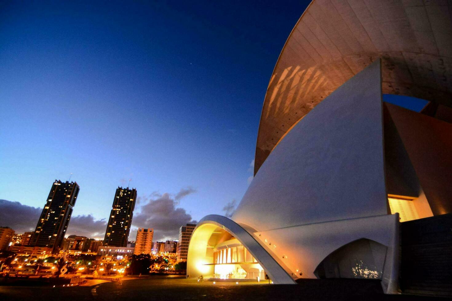 the opera house at night with the city in the background photo