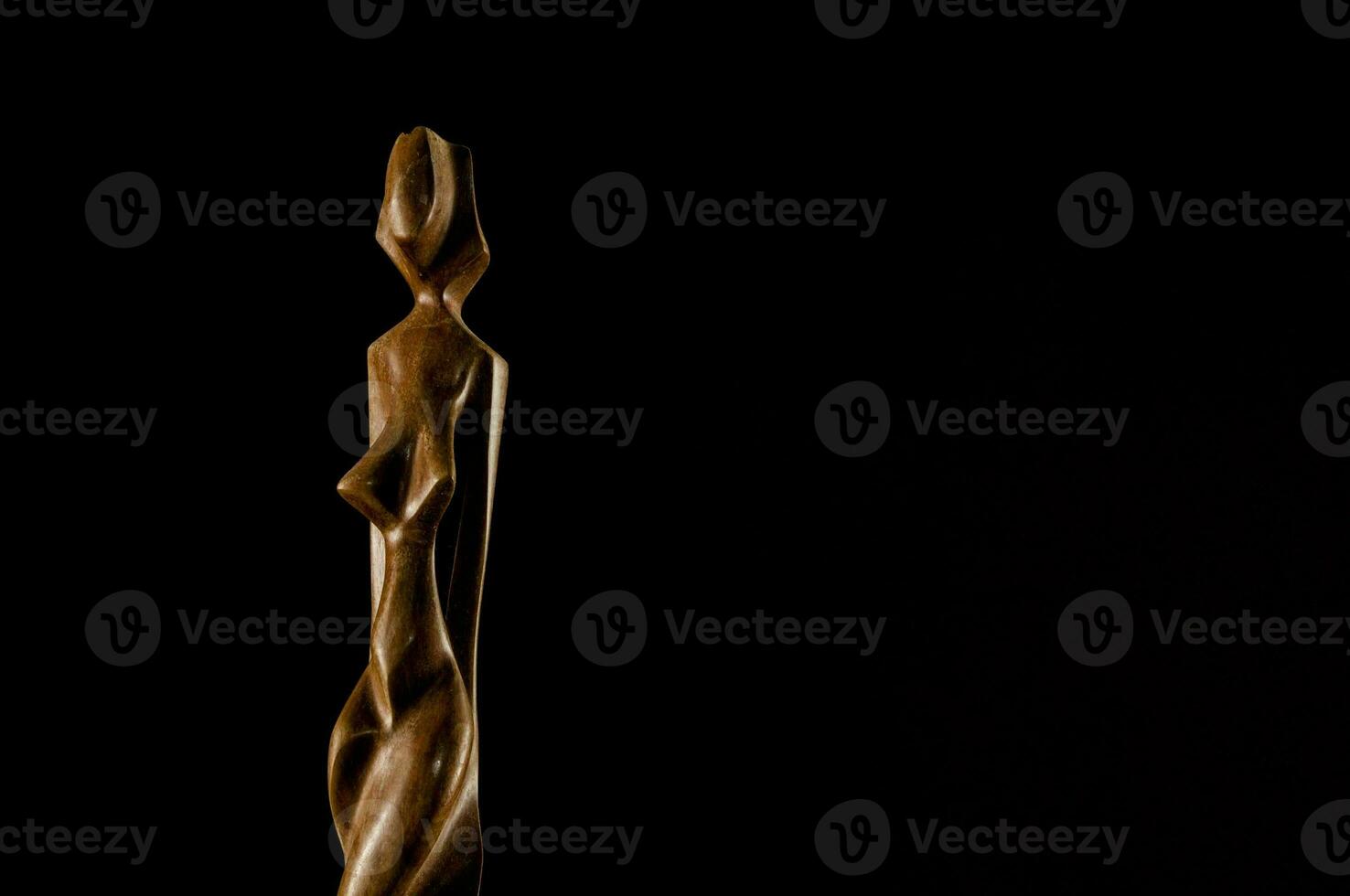 a wooden sculpture of a woman photo