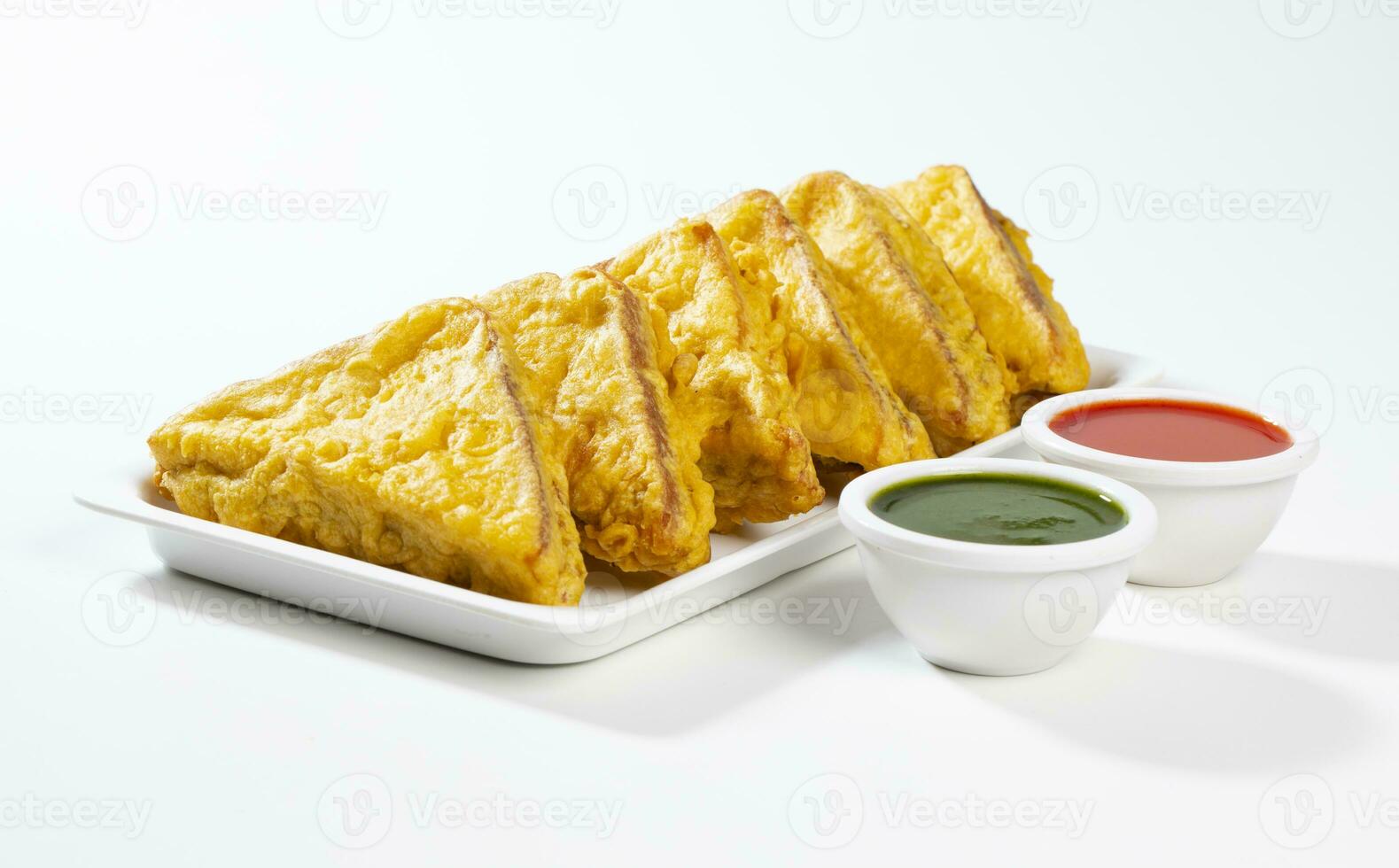 Indian Fried Snack Bread Pakora or Bread Bhaji Served with Tomato Ketchup, Green Chutney it is Made From Bread Slices photo