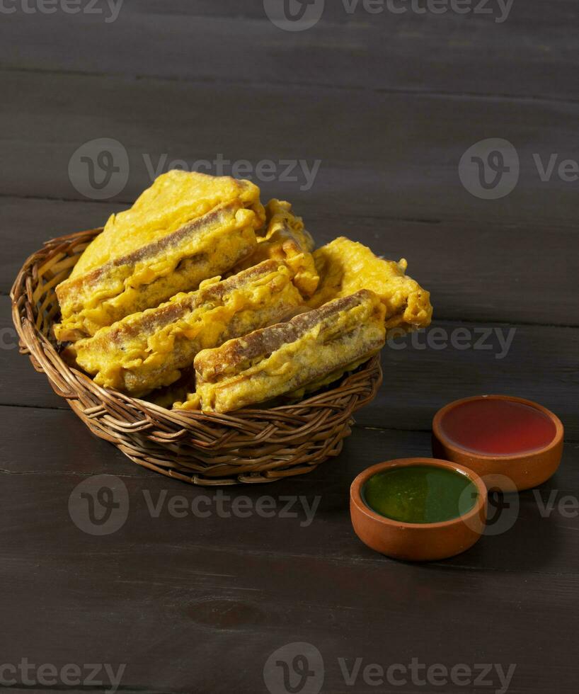 Indian Fried Snack Bread Pakora or Bread Bhaji Served with Tomato Ketchup, Green Chutney it is Made From Bread Slices photo