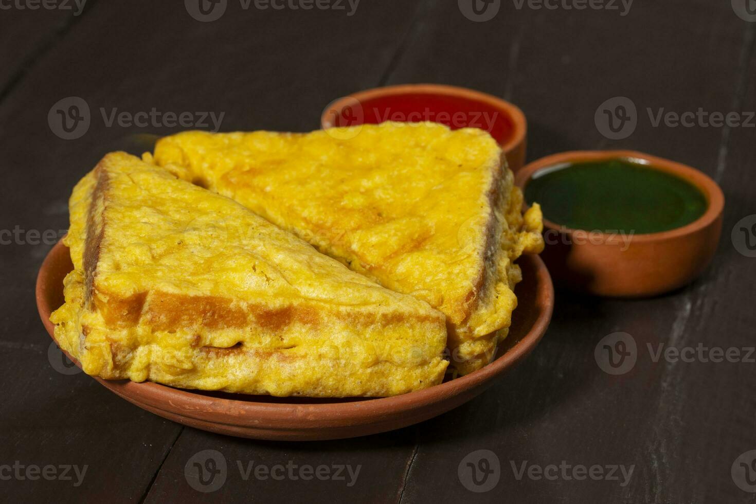 Indian Fried Snack Bread Pakora or Bread Bhaji Served with Tomato Ketchup, Green Chutney it is Made From Bread Slices photo