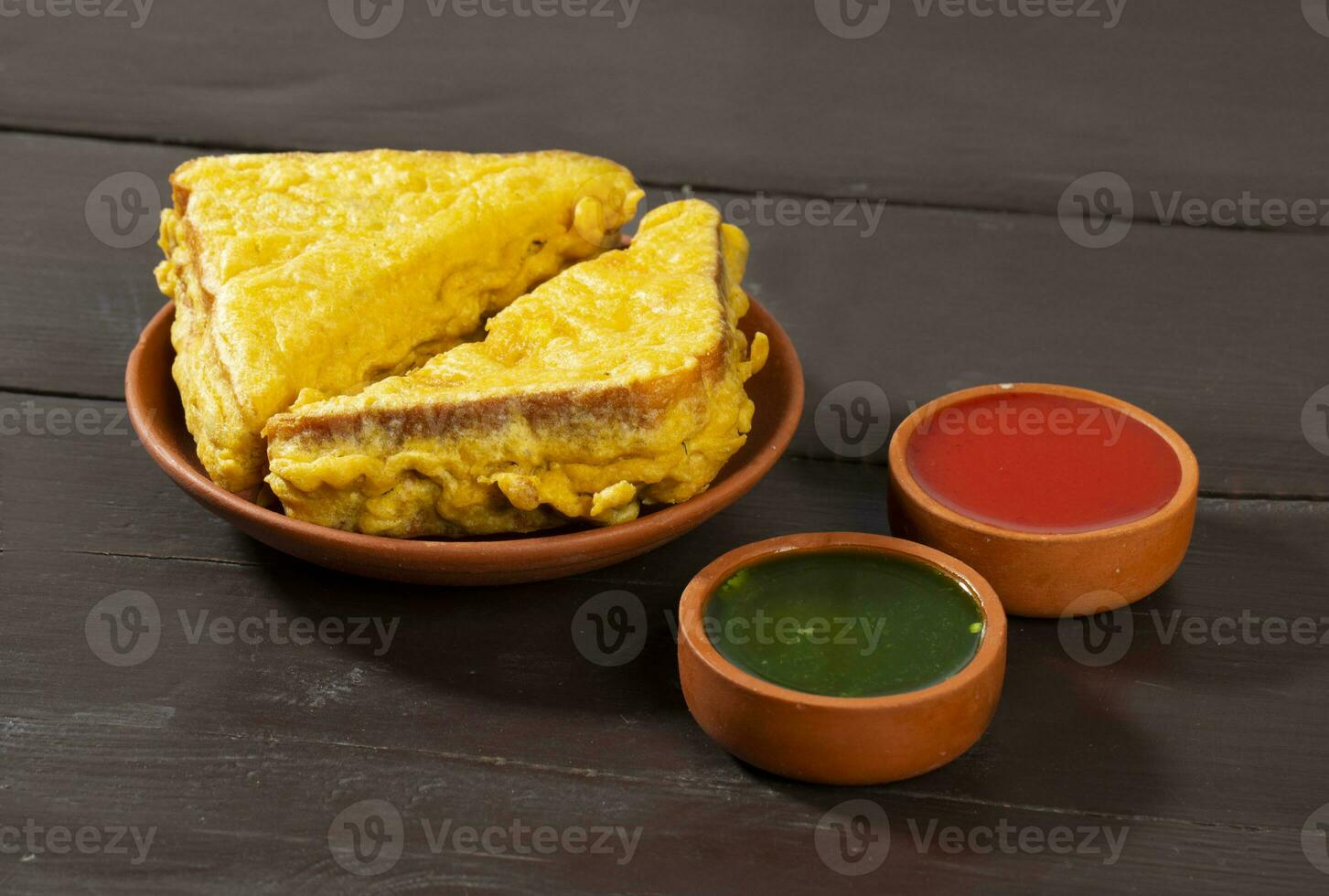Indian Fried Snack Bread Pakora or Bread Bhaji Served with Tomato Ketchup, Green Chutney it is Made From Bread Slices photo