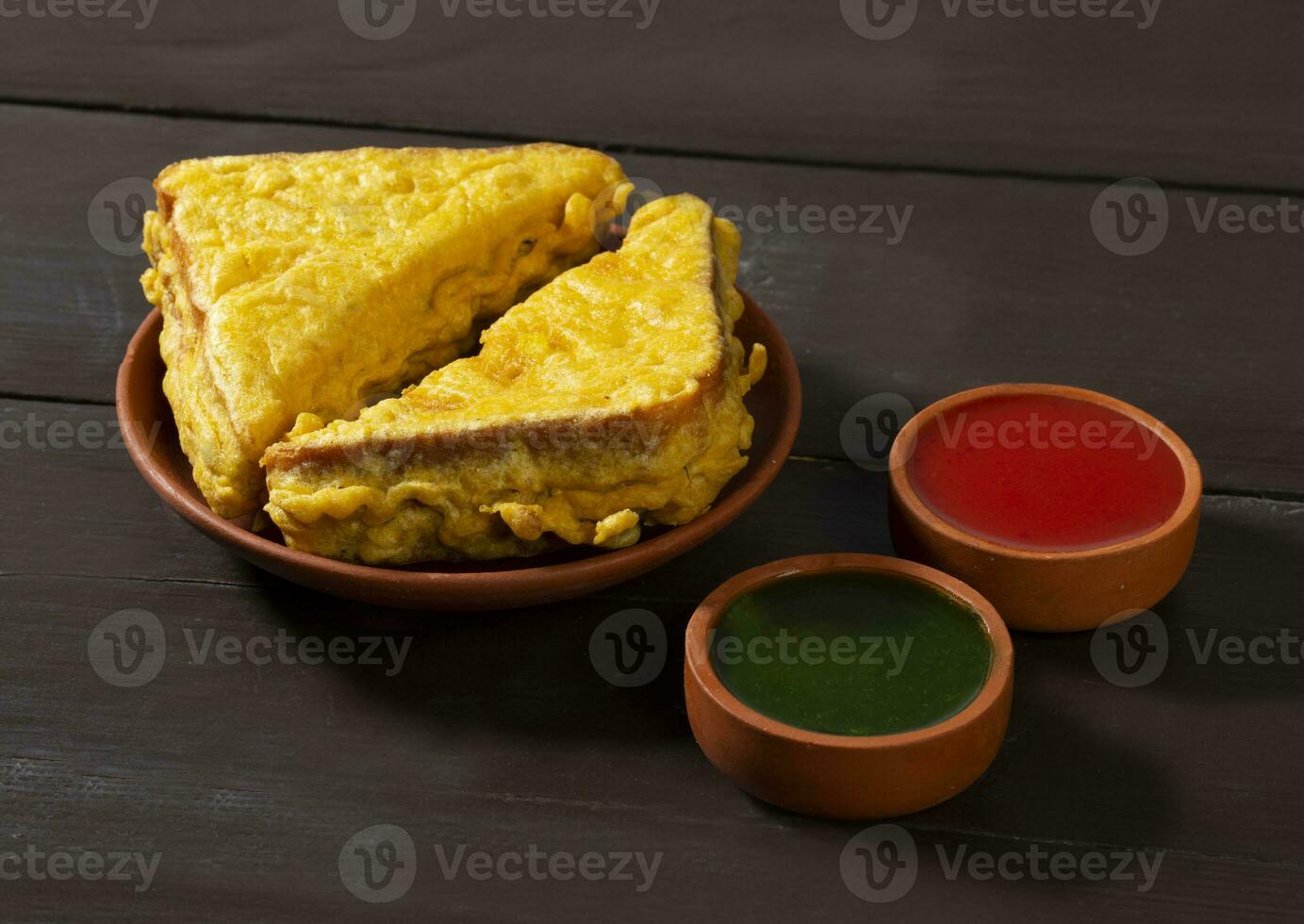 Indian Fried Snack Bread Pakora or Bread Bhaji Served with Tomato Ketchup, Green Chutney it is Made From Bread Slices photo