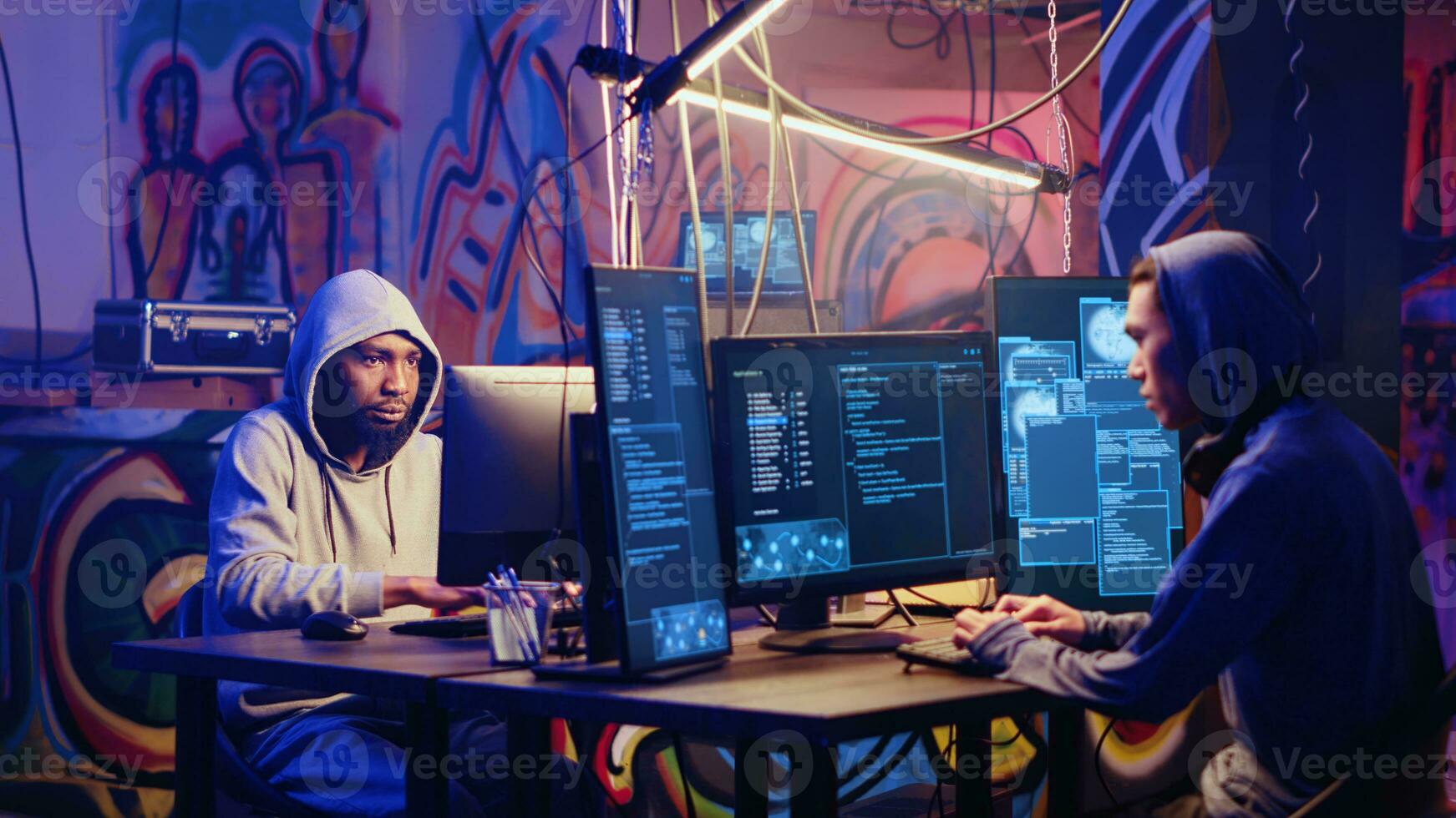 Hackers in hidden shelter hearing police sirens after launching DDoS attack on website, running in fear. Cybercriminals evading law enforcement after crashing businesses servers photo