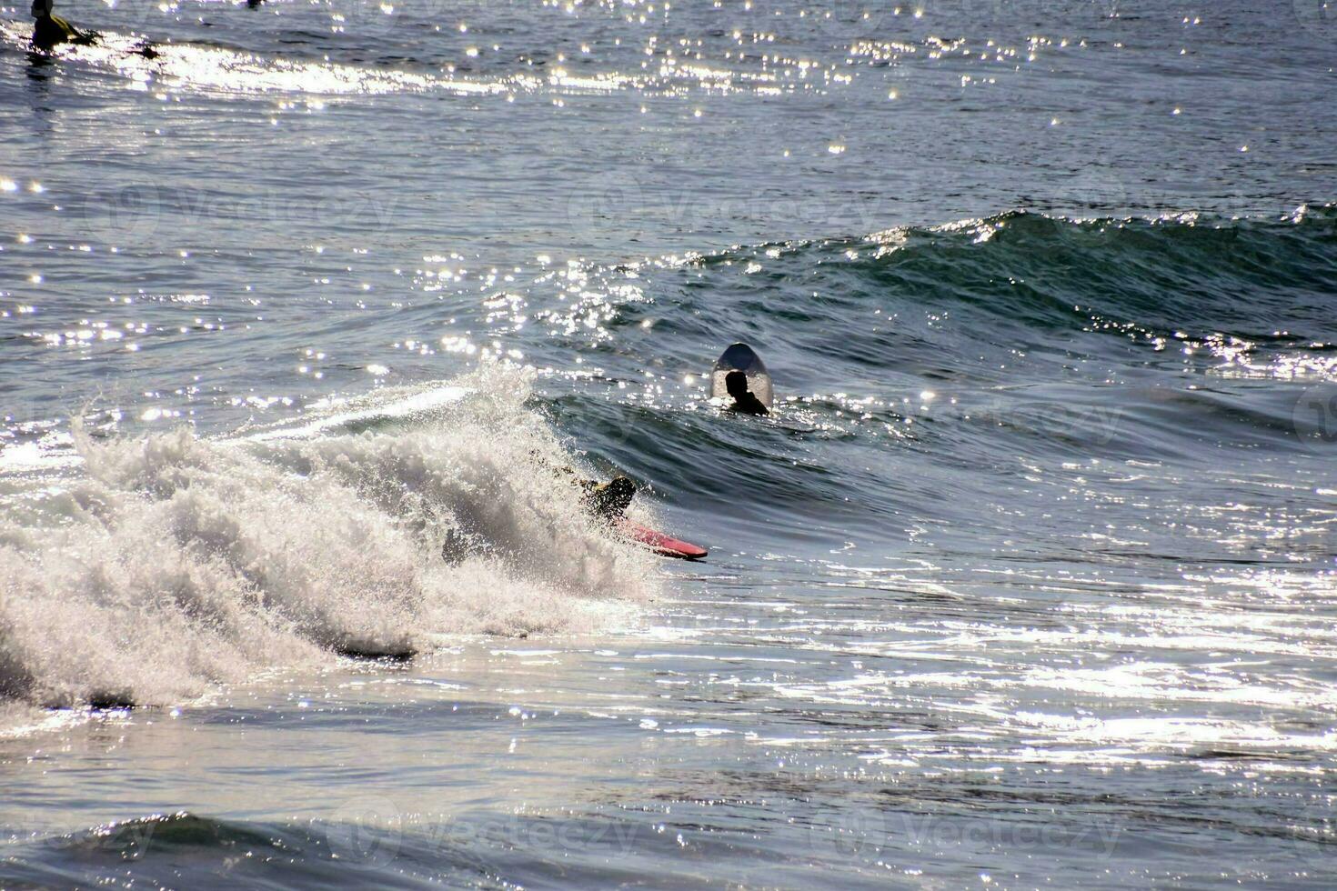 a surfer riding a wave in the ocean photo