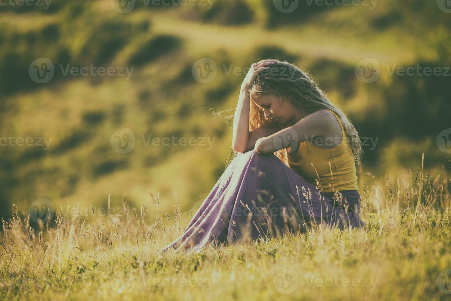 Sad woman sitting in nature photo