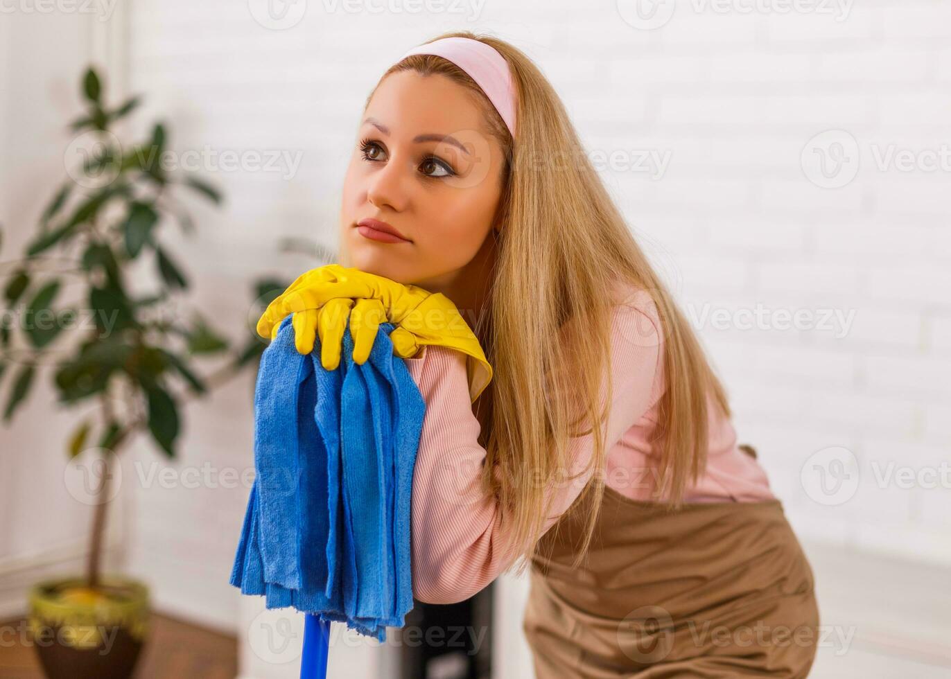 Tired housewife cleaning her home. photo