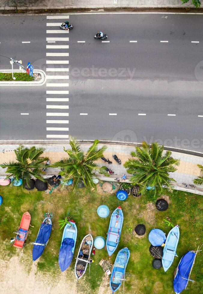 Drone view boats on the beach. Highway near seashore aerial shot. photo
