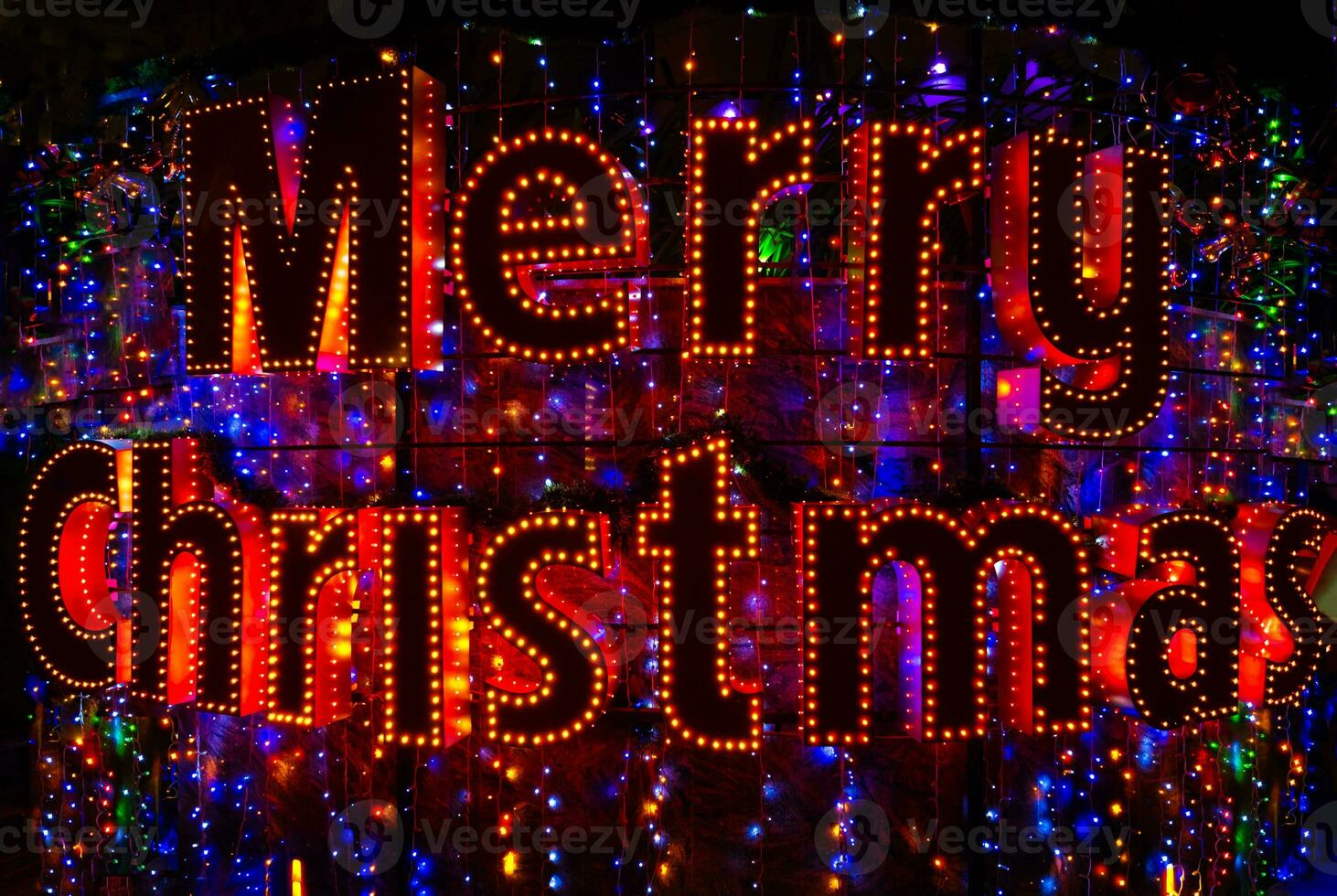 Merry Christmas word neon sign. Christmas lights in night city. photo