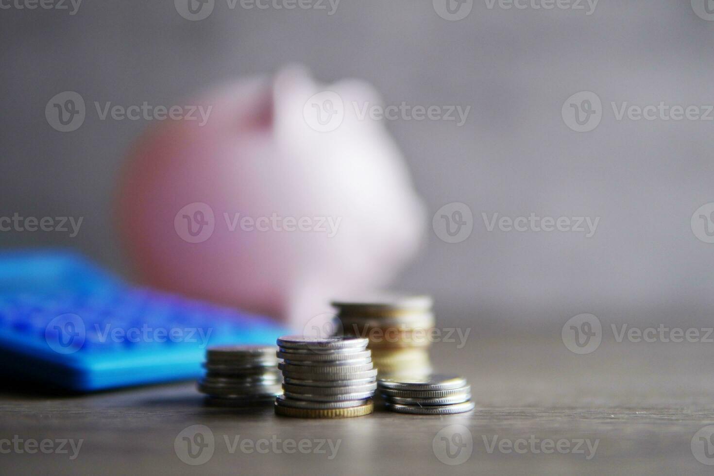 Selective focus image of coins, calculator and piggy bank with copy space for text. Financial concept. photo