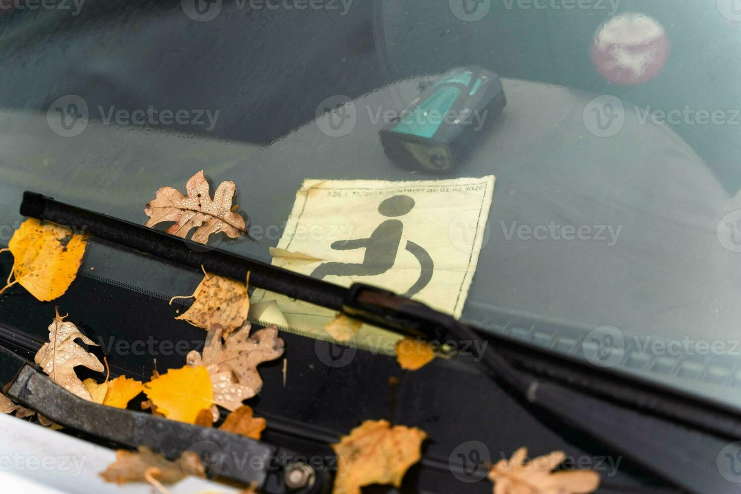 Close-up of a Car Window with a Disabled Driver Sign for Special Needs Accessibility photo