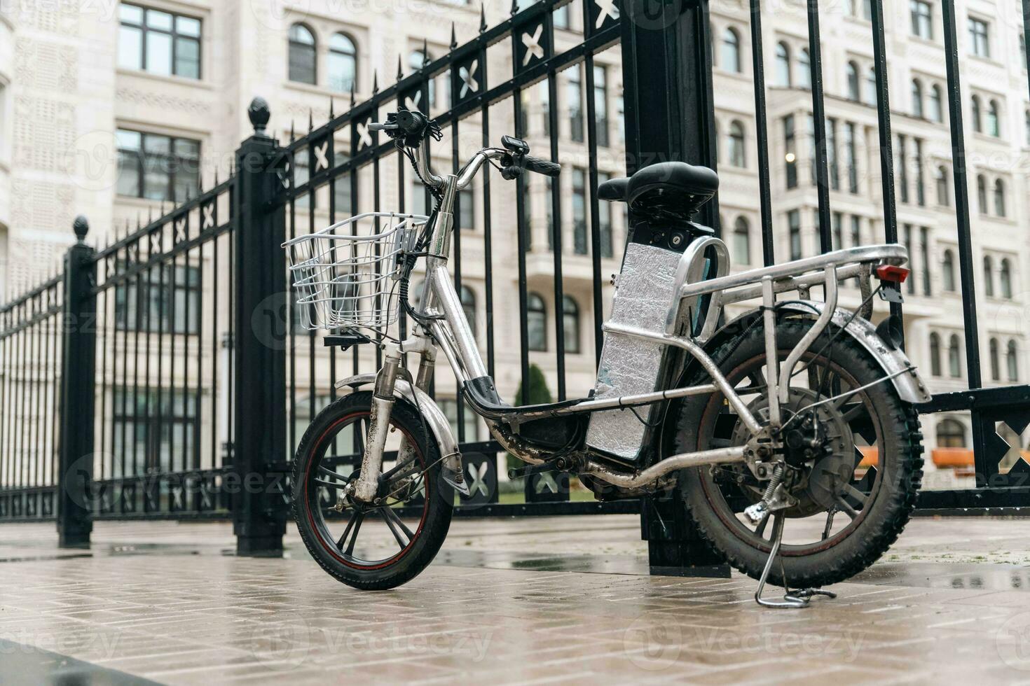 Modern electric bicycle parked on city street for delivery service photo