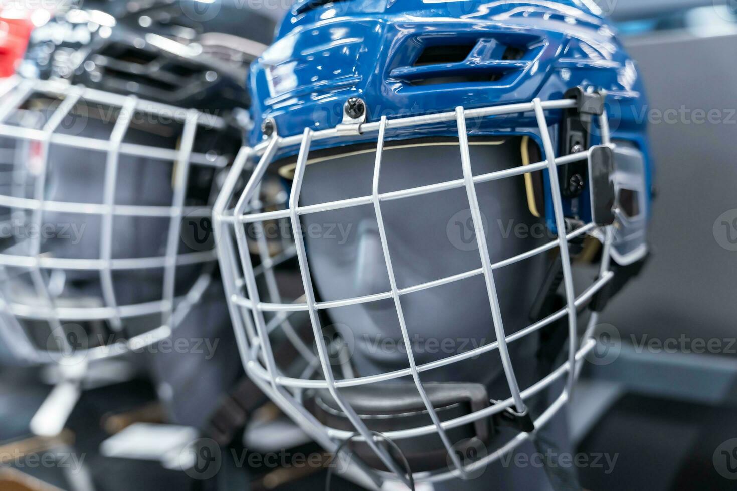 Sports Store Shelf Featuring Blue and Red Hockey Helmets with Visors photo