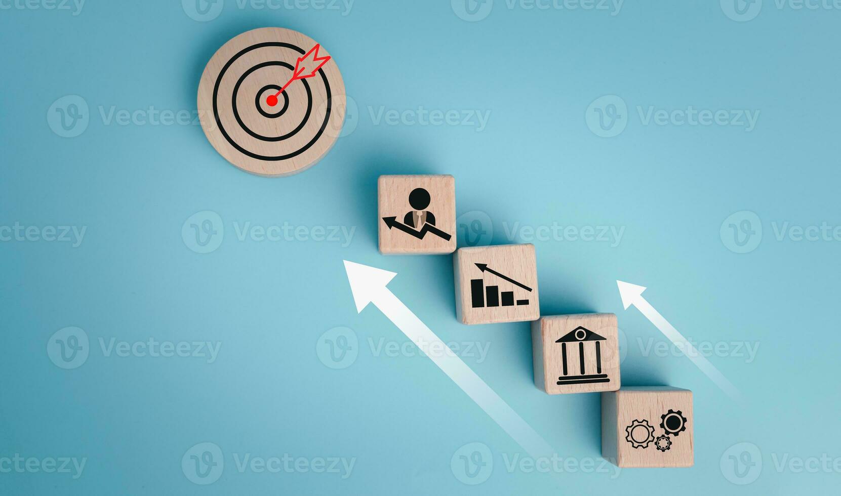 Circular wood with printed target icons and business symbols on white background, business goals and objectives concept, business competition. photo