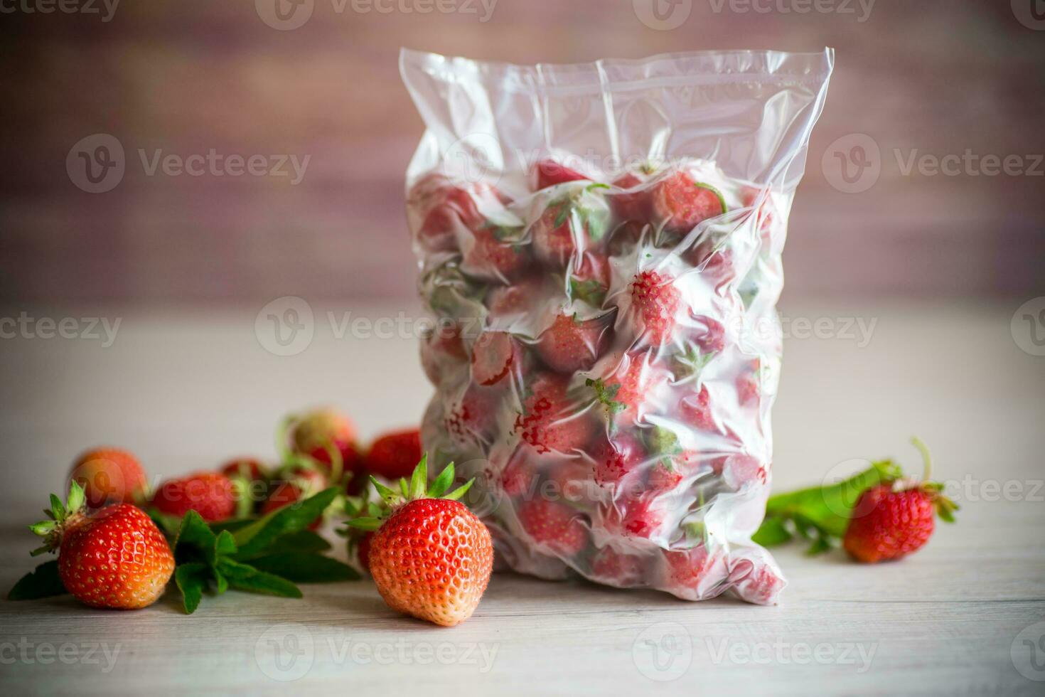 frozen fresh strawberries in a vacuum bag photo