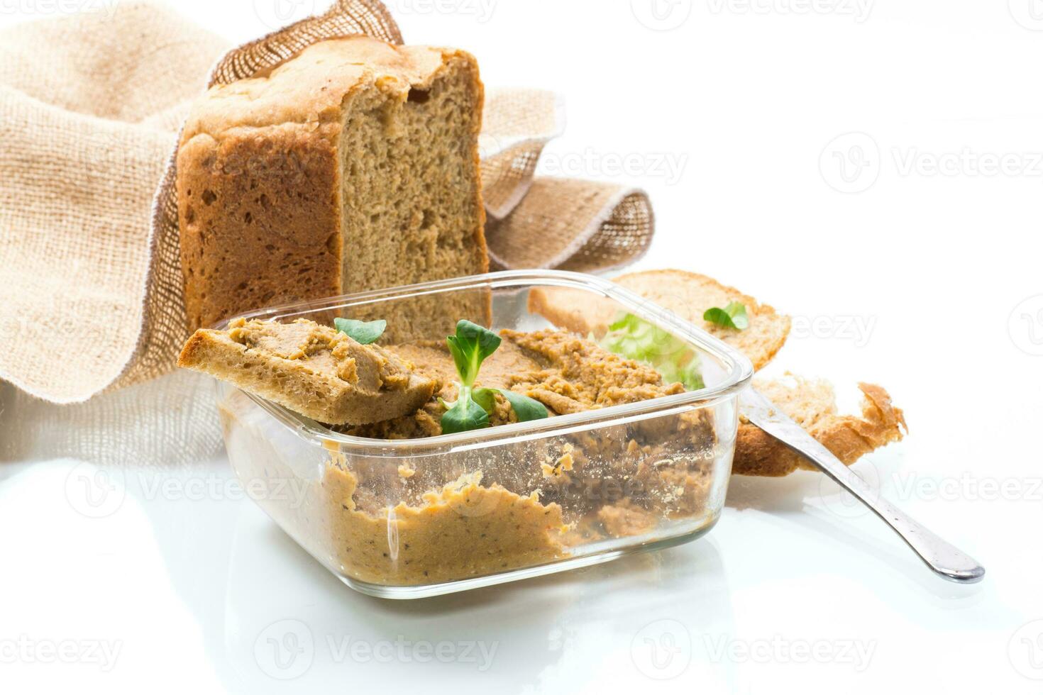 homemade meat pate with bread on a wooden table photo
