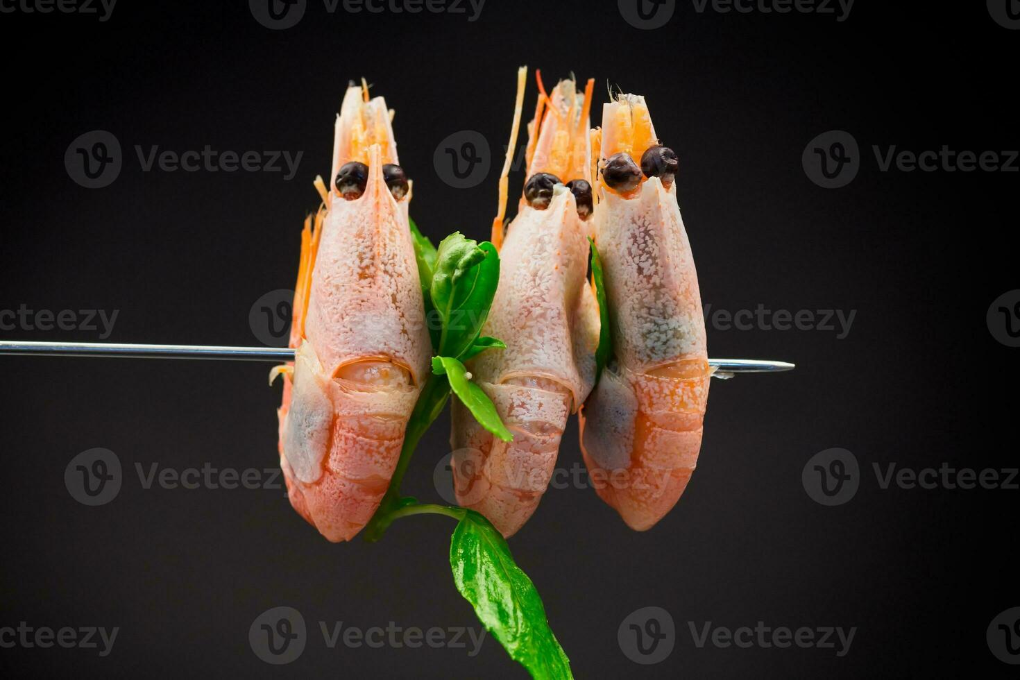 boiled shrimp with spices on black background photo