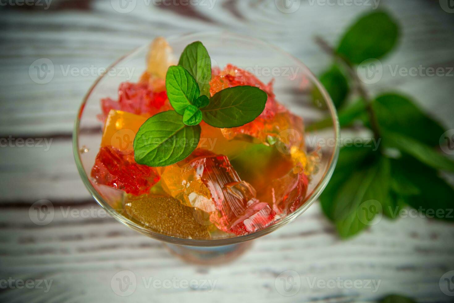 colored sweet fruit jelly in a glass glass photo