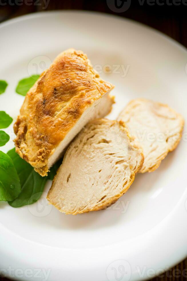 baked chicken fillet pieces with spices and herbs, in a ceramic form photo