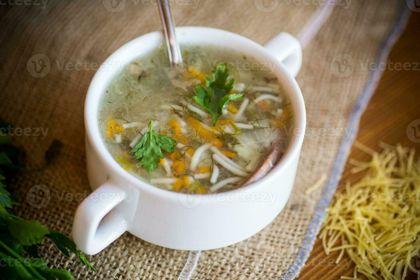cooked hot soup with noodles and vegetables photo