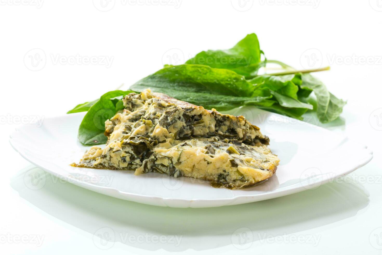 fried egg omelet with spring sorrel inside photo