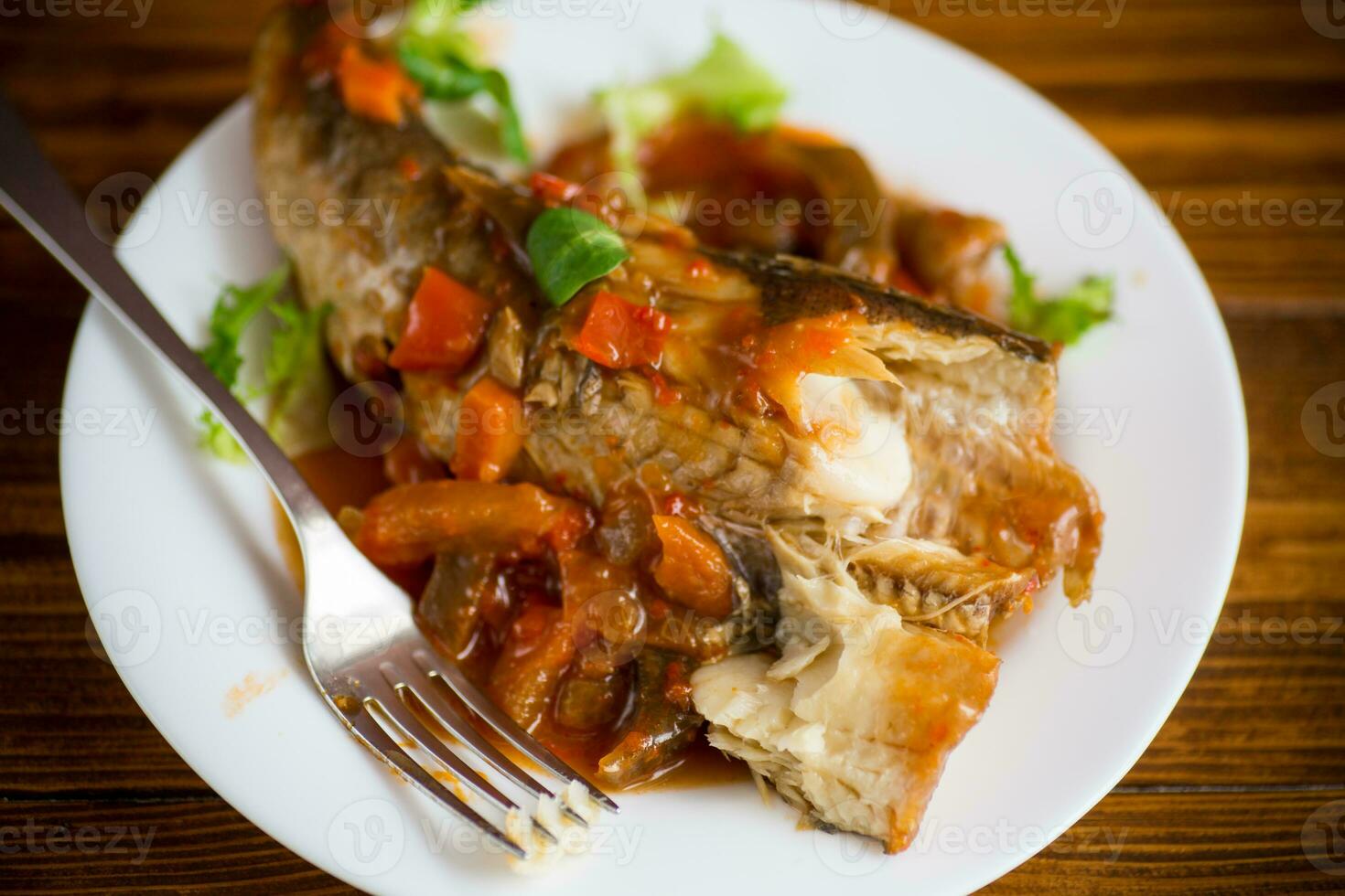 whole fish hake stewed with carrots, beets, peppers and other photo
