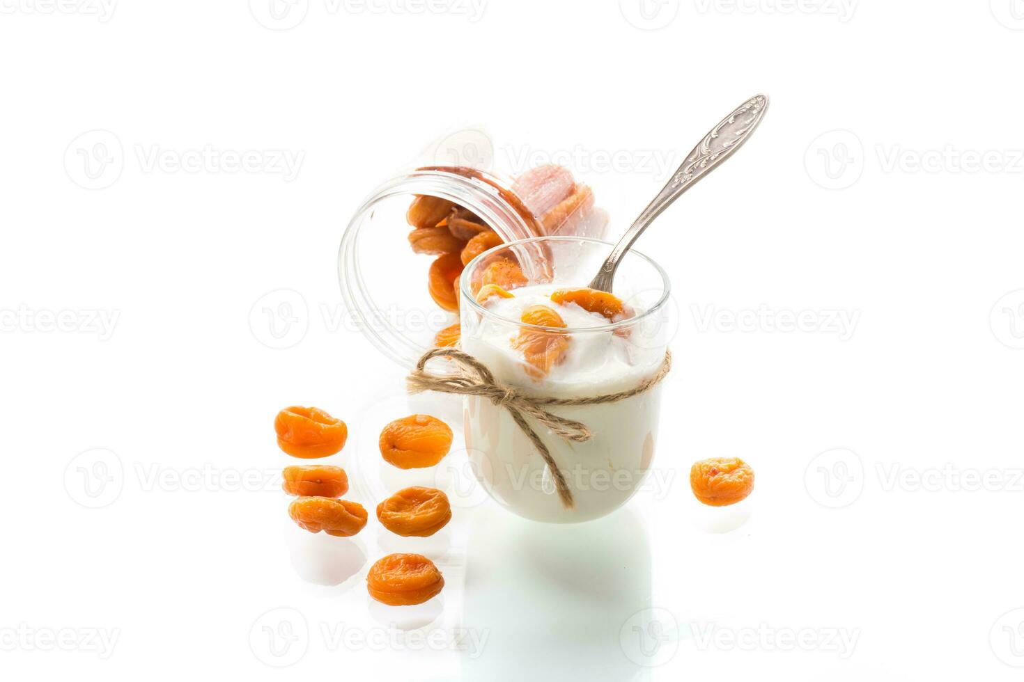 homemade sweet yogurt in a glass with dried apricots photo