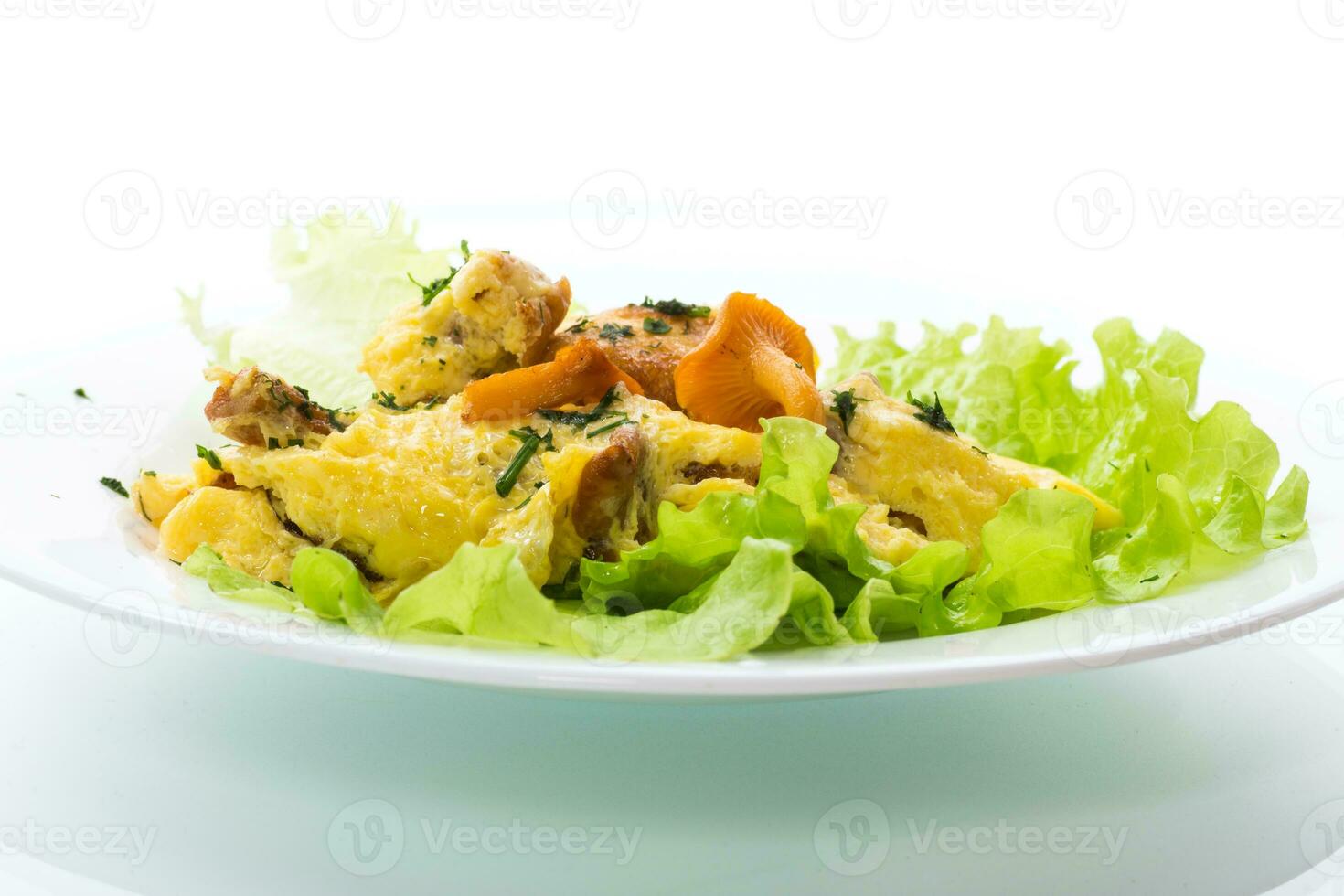 fried omelet with forest mushrooms chanterelles, on white background photo