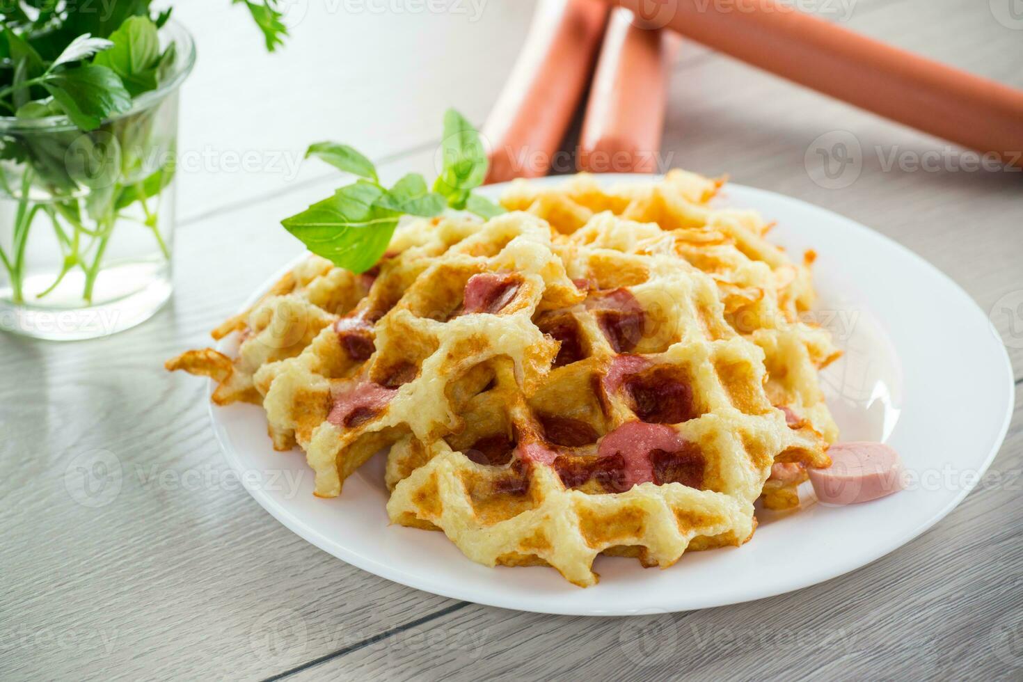 cooked fried potato waffles with sausage stuffing inside photo