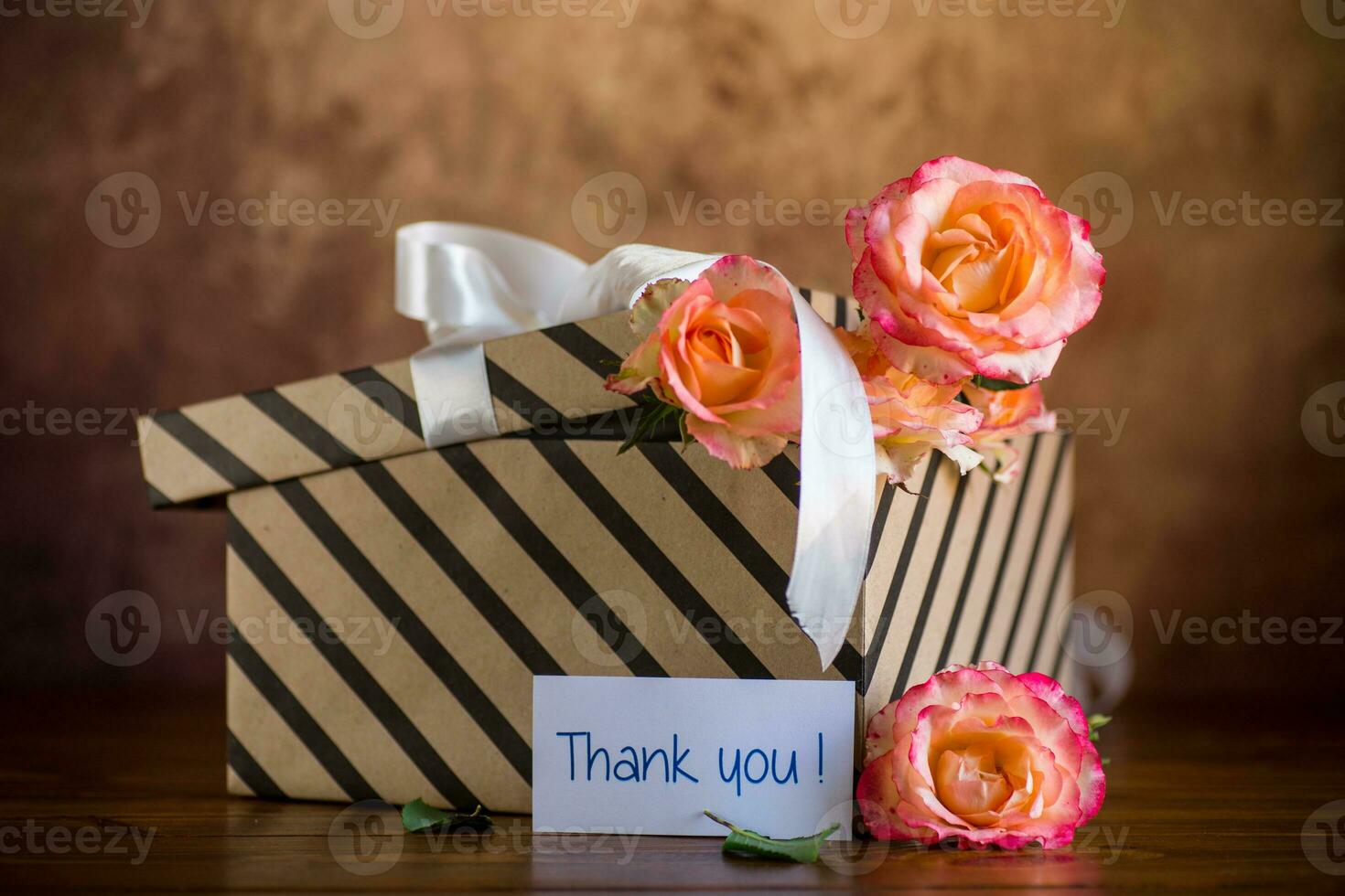 gift box with ribbons and beautiful roses inside. photo