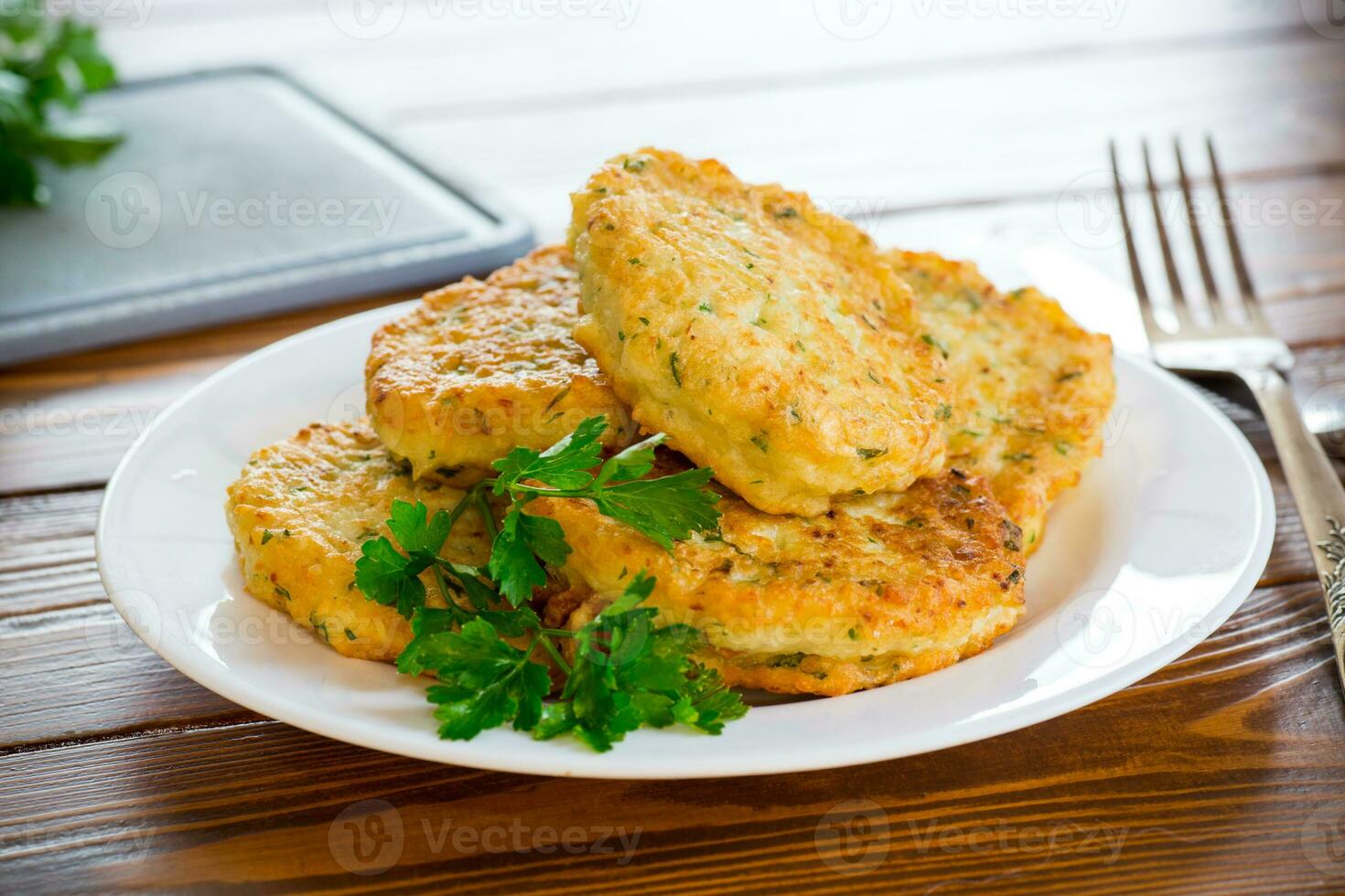 cooked fried potato cutlets with herbs photo