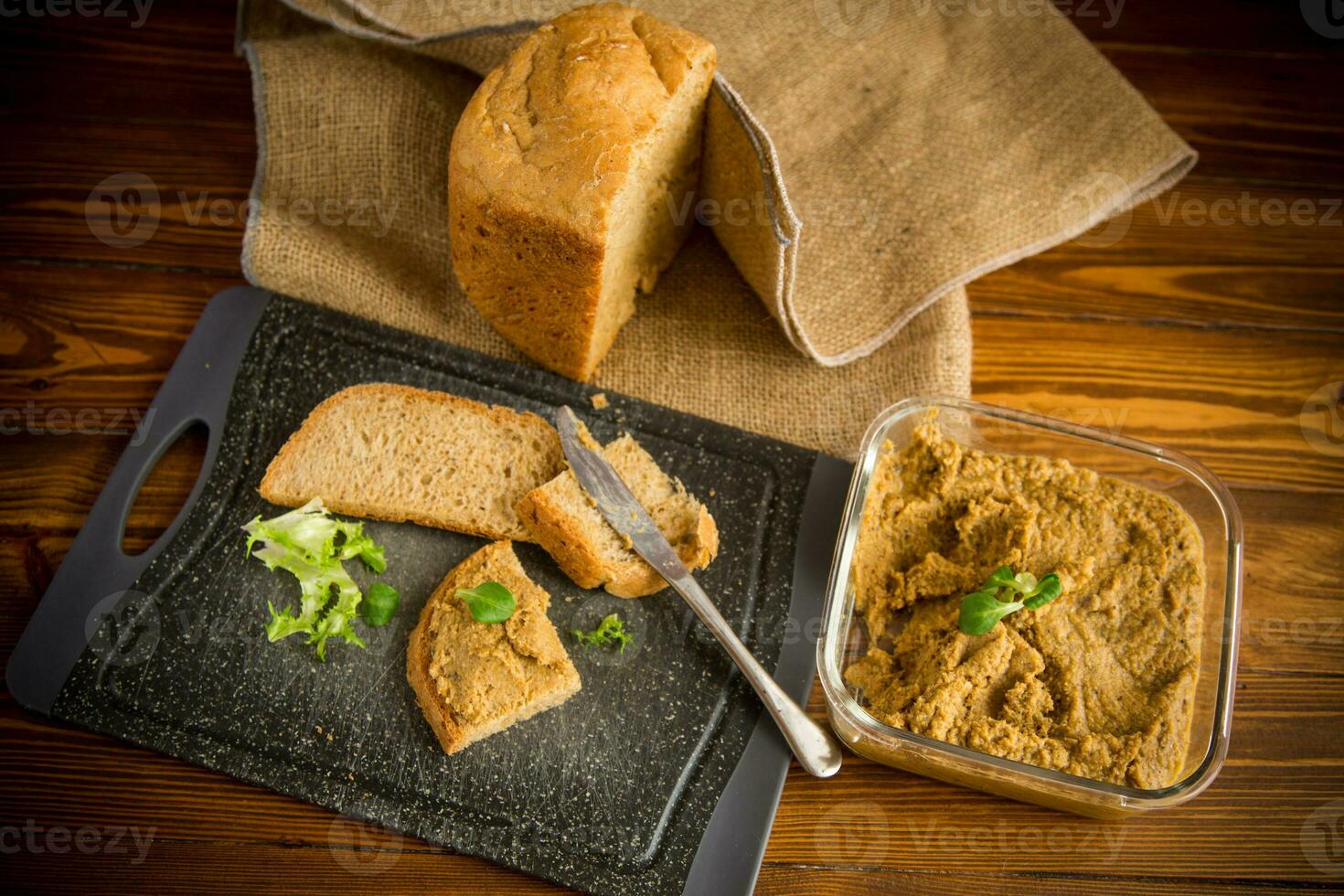 homemade meat pate with bread on a wooden table photo