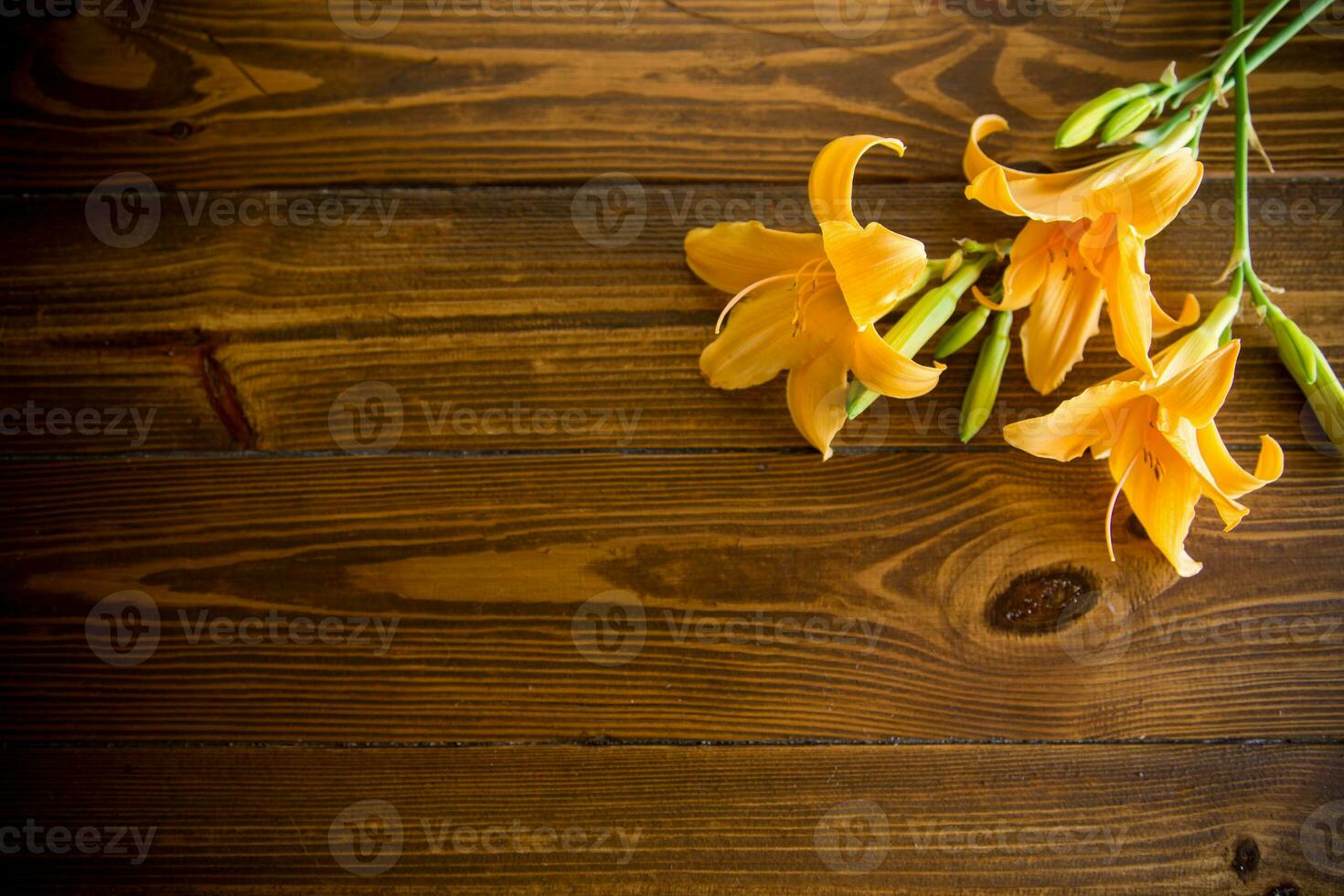 bouquet of beautiful yellow lilies on wooden table photo