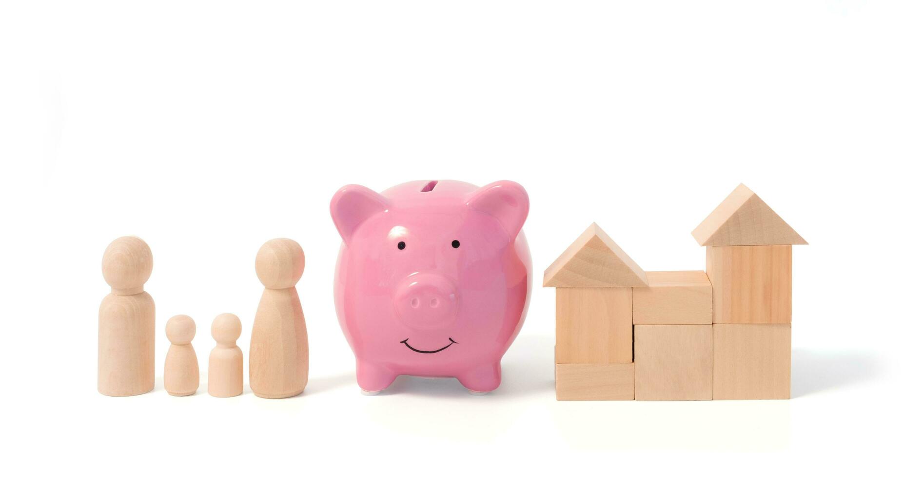 Wooden figurines of family father, mother, children, and pink piggy bank. Wooden figurines concept. model house on a white background. Real estate purchase, rental concept. warm family concept. photo
